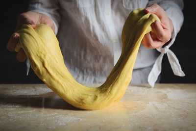 Midsection of woman preparing dough