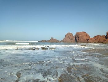 Scenic view of sea against clear blue sky