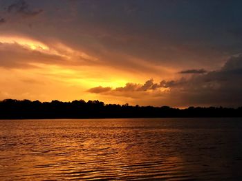 Scenic view of lake against romantic sky at sunset