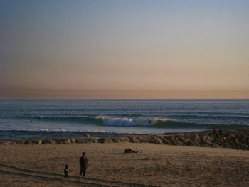 Scenic view of beach against sky during sunset