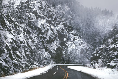 Road amidst snow covered mountain