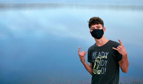 Portrait of boy standing in water