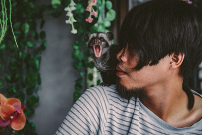 Close-up of young man with meerkat