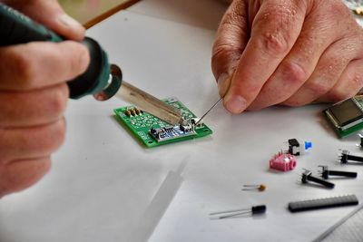 Cropped hand of man working on table