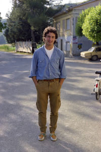 Portrait of young man walking on street