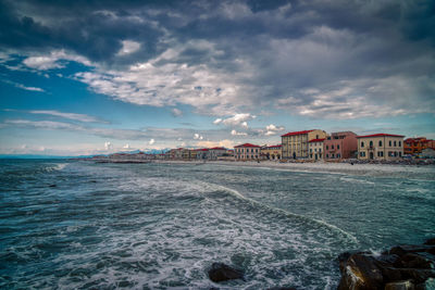 Scenic view of sea against buildings