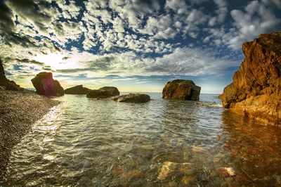 View of calm sea against cloudy sky