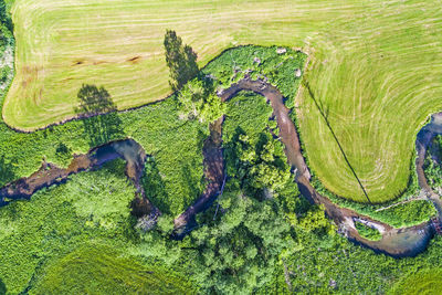 High angle view of river amidst green landscape