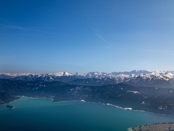 Scenic view of snowcapped mountains against blue sky