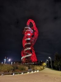 Low angle view of illuminated ferris wheel against sky at night