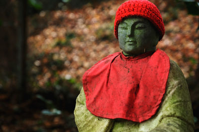 Close-up of statue against red sculpture