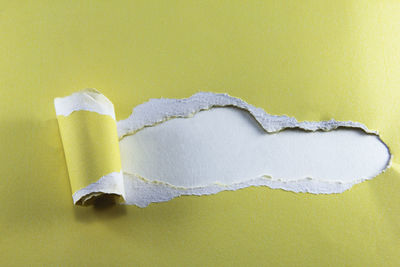 Close-up of yellow paper over white background