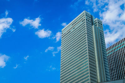 Low angle view of modern building against blue sky