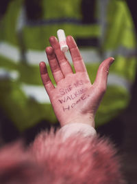 Hand of a person with text she was walking home