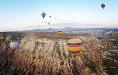 Hot air balloons flying over landscape