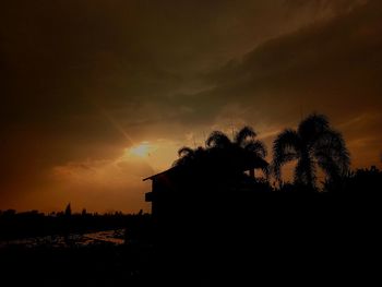 Silhouette trees against sky during sunset