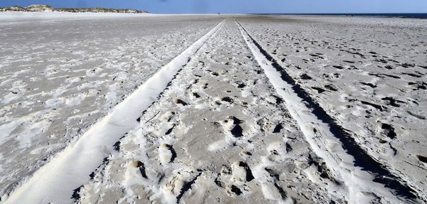 Close-up of sand on beach against sky