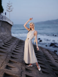 Rear view of woman standing at beach