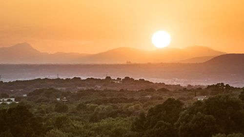 Scenic view of landscape against sky during sunset