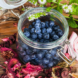 High angle view of berries in glass jar on table