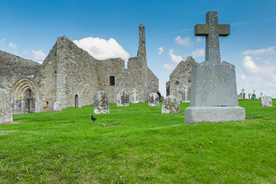 Tombstones in cemetery against sky