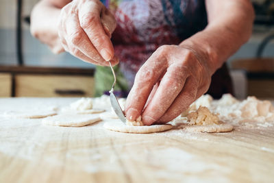 Midsection of person preparing food on table