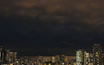 High angle view of city lit up at night