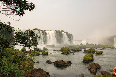 Scenic view of waterfall against clear sky