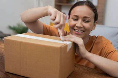 Midsection of woman holding box