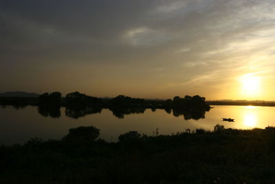 Scenic view of calm lake at sunset