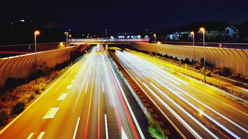 High angle view of light trails on highway at night