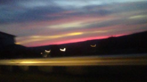 Scenic view of silhouette field against sky at night