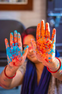 Colorful hand at holi celebration with multicolor from flat angle