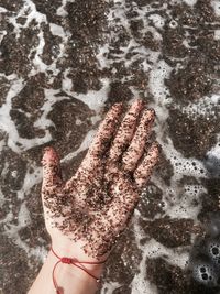 Close-up of sand on hand