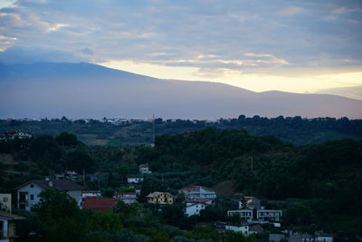 Houses on mountain against sky