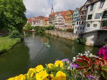 Scenic view of river by buildings against sky