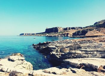 Scenic view of sea against clear blue sky