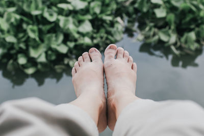 Low section of woman over pond