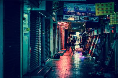 Woman in illuminated city at night