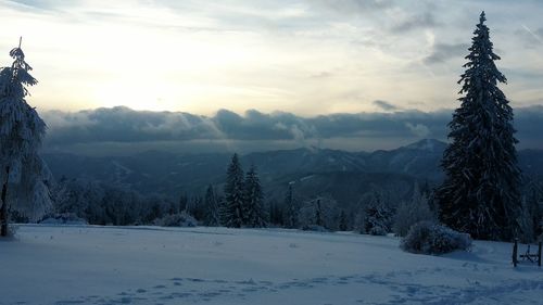 Scenic view of snow covered mountains against sky