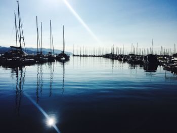 Sailboats in sea against blue sky