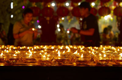 Lit diyas in temple at night