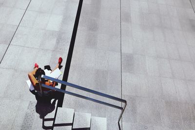 High angle view of woman sitting outdoors