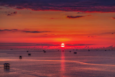 Scenic view of sea against romantic sky at sunset