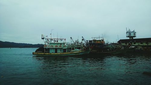 Fishing boat in sea against sky