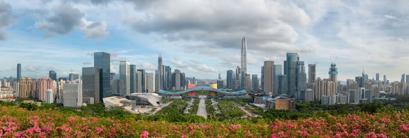 Panoramic view of buildings in city against sky