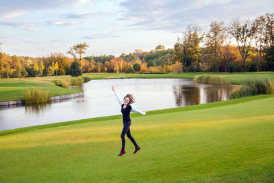 Full length of man standing on golf course against sky