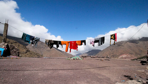 Clothes drying on clothesline against sky