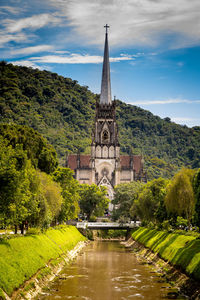 View of temple building by trees against sky