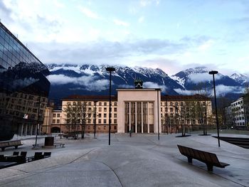 Snow covered mountain against cloudy sky
